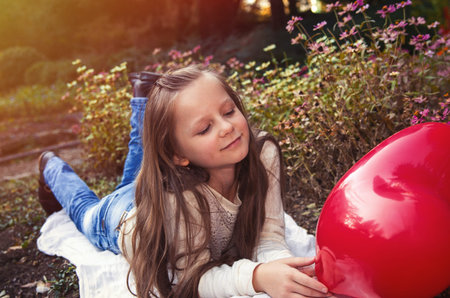 pretty girl in the autumn park with baloonsの写真素材