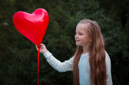 pretty girl in the autumn park with balloonの写真素材