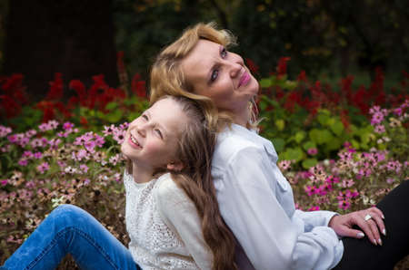mother and daughter in the autumn parkの写真素材