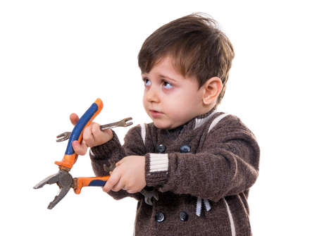 little boy with the pliers on whiteの写真素材