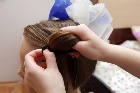 doing hair style to the girl