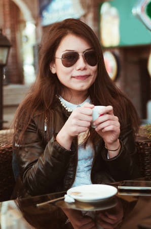 girl having coffee closeup.shallow DOFの写真素材