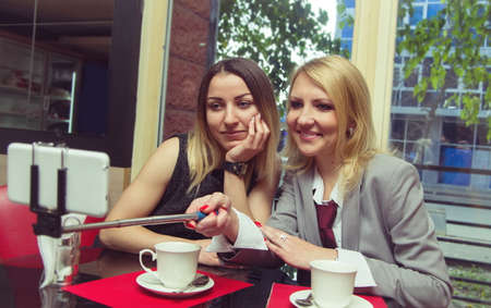 two business women in old cafe doing selfieの写真素材