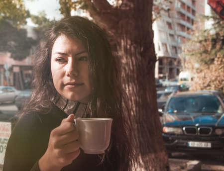 girl having coffee closeup.shallow DOFの写真素材