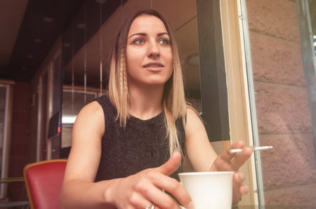 woman having coffee in cafeの写真素材