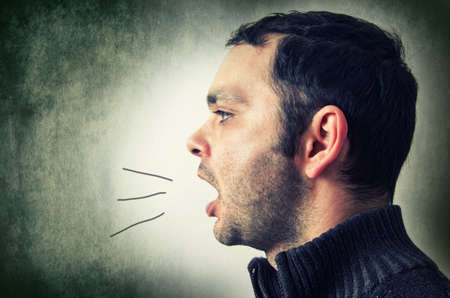 man with open mouth shoutingの写真素材