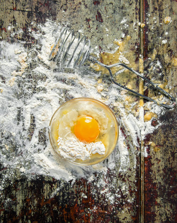 breaking the egg into the dough..の写真素材