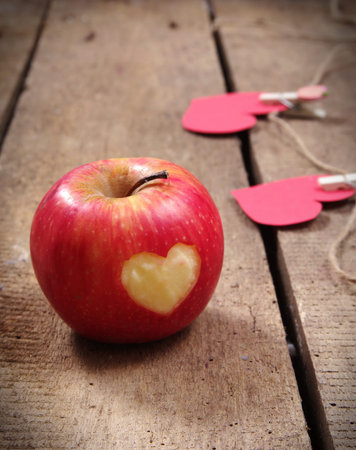 apple with heart on table