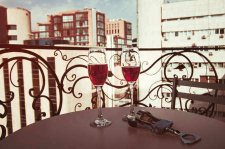 glasses of wine on the balconyの写真素材