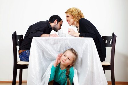 little girl listening to adults secretsの写真素材