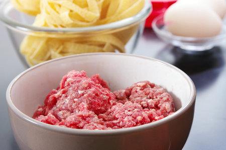 raw mince, pasta and eggs are ready to cook