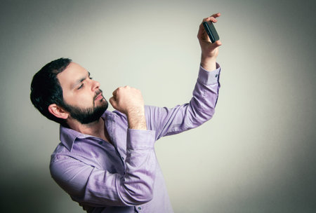 man with beard taking selfie