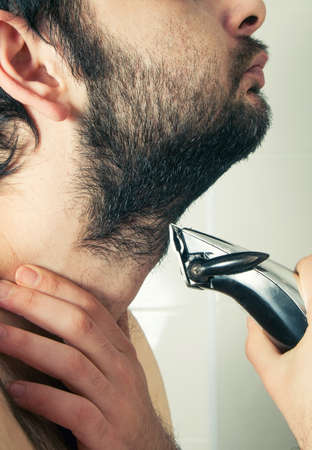 man trimming beard hair closeupの写真素材