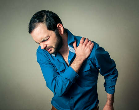 bearded man has a shoulder painの写真素材