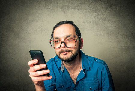 geek with the beard and phoneの写真素材