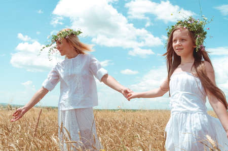 mother and daughter in the wheat fieldの写真素材