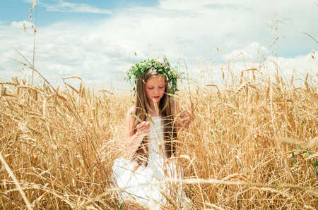little girl in the wheat fieldの写真素材