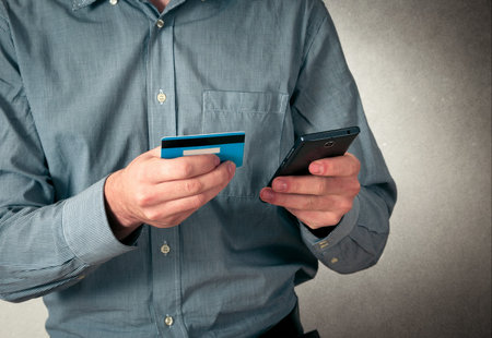 man using credit card on phone