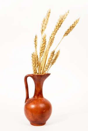 Jar with wheat on whiteの写真素材