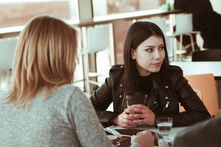 Girls sitting in the cafeの写真素材