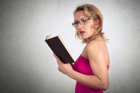 Beautiful blond woman reading book
