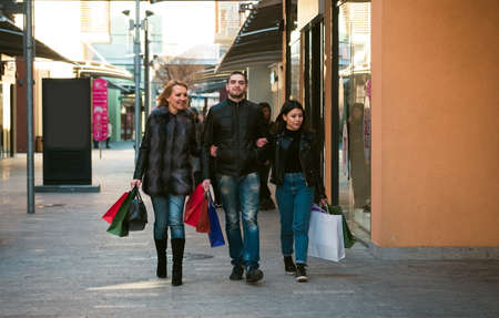 Happy friends making shoppingの写真素材