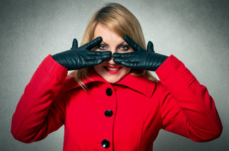 Pretty woman in winter clothes closing eyesの写真素材