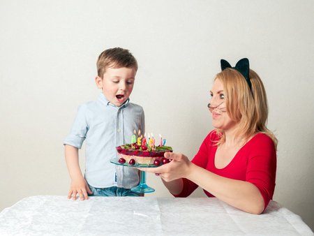 Little boy with mum and the birthday cakeの写真素材