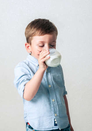 Little boy drinking milkの写真素材