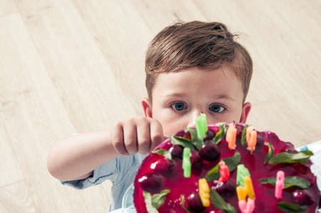 Little boy with the birthday cakeの写真素材