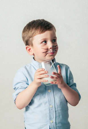 Little boy drinking milkの写真素材