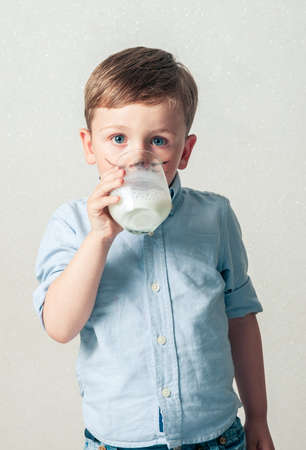 Little boy drinking milkの写真素材