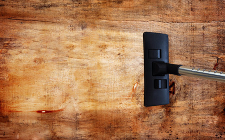 Vacuum cleaner on wood surfaceの写真素材