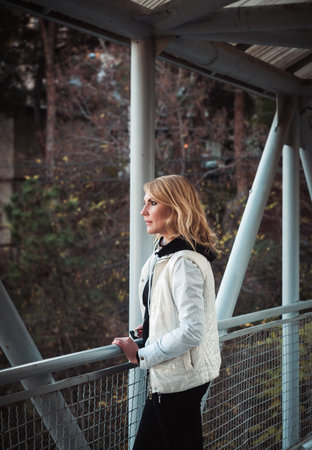 Blond woman on the bridge. Autumn timeの写真素材