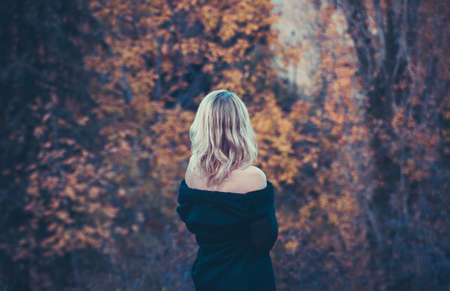 Beautiful blond woman in autumn parkの写真素材
