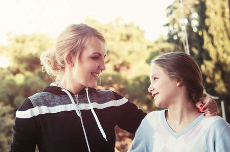 Mother with daughter talking. Autumn timeの写真素材