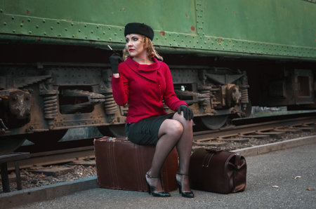Retro woman on the train stationの写真素材