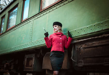 Retro woman on the train stationの写真素材