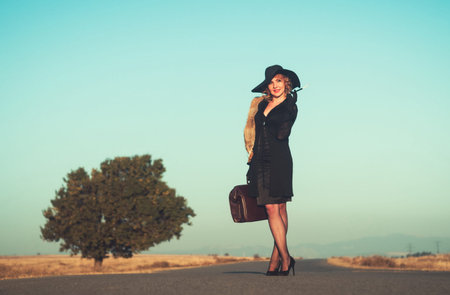 Retro beautiful blond woman portrait on road