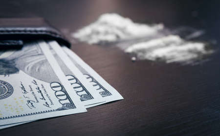 Cocaine powder on the table with moneyの写真素材