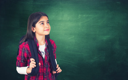 Young girl portrait with the school chalkboard