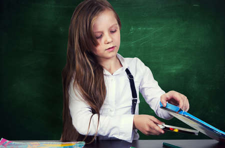 Young girl portrait with the school chalkboardの写真素材