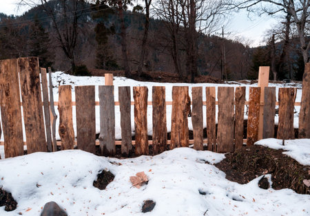 Wooden fence with the snow