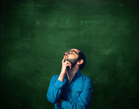 Bearded man on chalkboard background