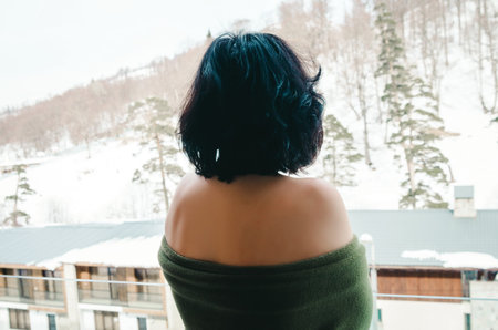 Brunette woman on the balcony in winter time