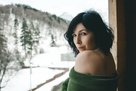Brunette woman on the balcony in winter timeの写真素材