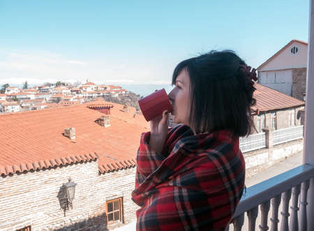 Woman on balcony with coffeeの写真素材