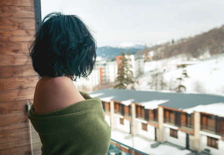 Brunette woman on the balcony in winter timeの写真素材