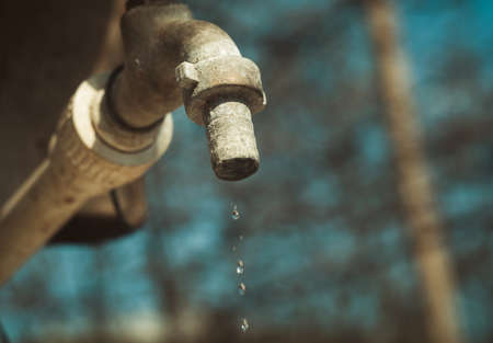 Old tap outdoors with the water dropsの写真素材