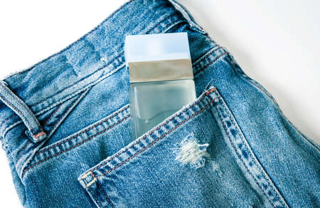 Bottle of perfume on the jeansの写真素材